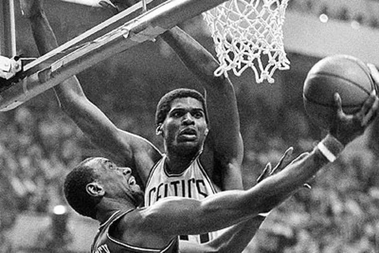 Andrew Toney slips by Boston's Robert Parish for two during Game 7 of the 1982 Eastern Conference Finals at Boston Garden. (AP file photo)