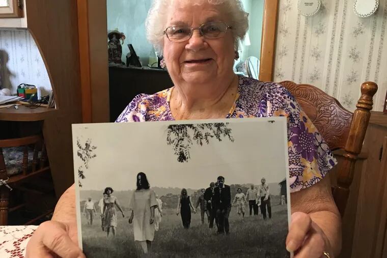Ella Mae Smith, 86, of Evans City, holds up a publicity photo from “Night of the Living Dead.” It’s turning 50 this year.