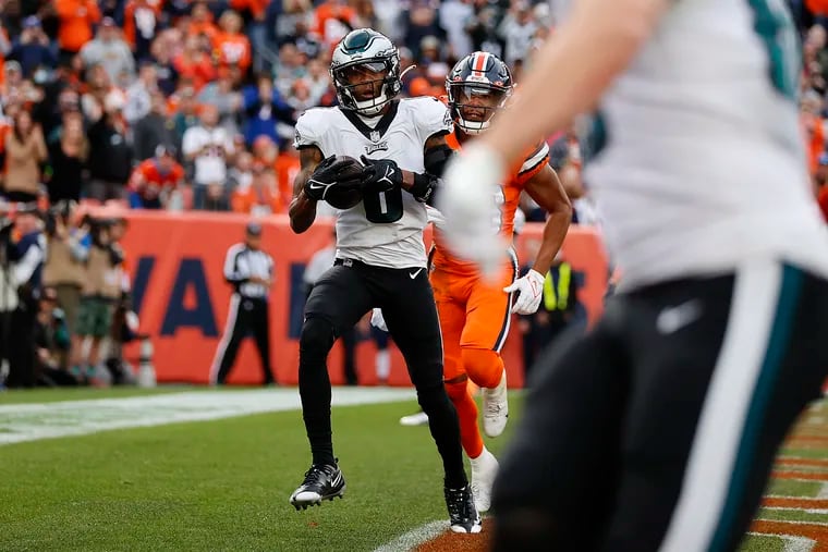 Philadelphia Eagles wide receiver DeVonta Smith (left) catches a pass for a touchdown in the second quarter against the Broncos. Eagles play the Broncos in Denver, Colo. on Sunday, Nov. 14, 2021.
