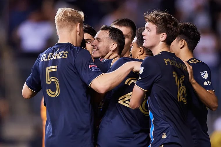 Jack McGlynn (right), Jakob Glesnes, and others celebrate with Dániel Gazdag (center) after Gazdag's goal in the Union's 1-0 win over Atlas.