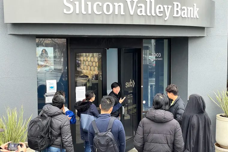 A worker tells customers that the Silicon Valley Bank headquarters is closed on Friday in Santa Clara, Calif. Silicon Valley Bank was shut down by California regulators and was put in control of the U.S. Federal Deposit Insurance Corp.