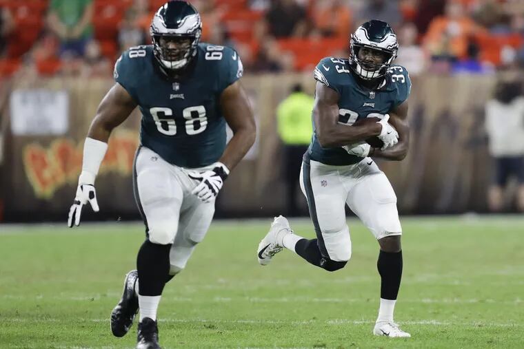 Eagles running back Josh Adams runs with the football behind offensive tackle Jordan Mailata against the Cleveland Browns during a preseason game at FirstEnergy Stadium in Cleveland on Thursday, August 23, 2018. YONG KIM / Staff Photographer