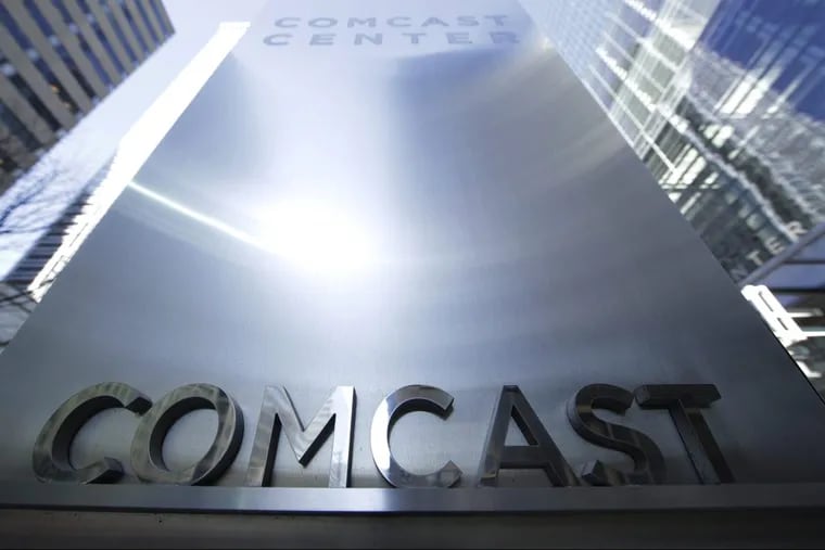 FILE photo shows Comcast signage outside the company headquarters in Philadelphia.