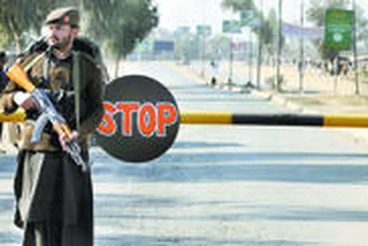 A Pakistani paramilitary soldier stands guard at a checkpost on the Jamrud Road, leading to Afghanistan, after its closure.