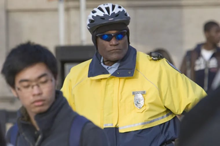 A police officer outside South Phila. High School in December 2009. (David M Warren / Staff Photographer)