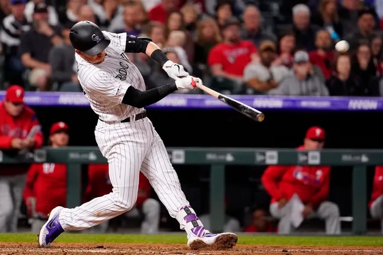 Colorado Rockies' Trevor Story (27) hits a solo homer against the Philadelphia Phillies during the sixth inning of a baseball game Friday, April 19, 2019, in Denver.