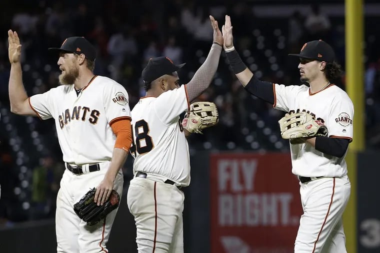 San Francisco Giants (from left) Hunter Pence, Pablo Sandoval and Jarrett Parker celebrate after a game against the Phillies in San Francisco, Thursday, Aug. 17, 2017. The Giants won, 5-4.
