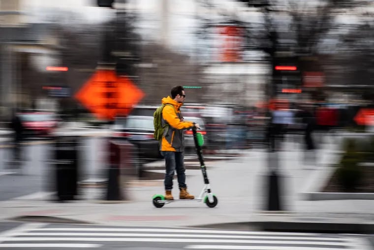 An e-scooter zips along a Washington, D.C., street. Pennsylvania lawmakers Greg Rothman (R-Cumberland) Stephen Kinsey have introduced a bill to legalize on-the-road scooter use in the state.