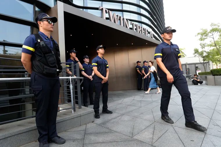 South Korean police officers stand guard against possible rallies against Japan in front of a building where the Japanese embassy is located in Seoul, South Korea, Friday, July 19, 2019. South Korean police say a man has set himself on fire in front of the Japanese Embassy in Seoul amid rising trade disputes between Seoul and Tokyo. (AP Photo/Ahn Young-joon)
