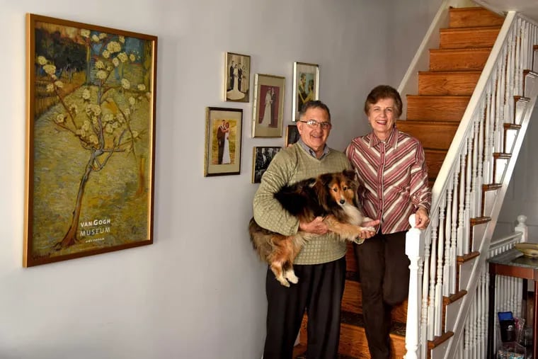 Elena and Joseph Cappella pose in their Fitler Square home with their Sheltie, Nessie, a certified therapy dog Elena works with.