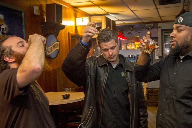 Regulars raise a toast to their years at Towey’s Tavern. From left are Andrew Walls of Mount Airy, Chris Bond of Chestnut Hill, and Harvey Nelson of Olney.