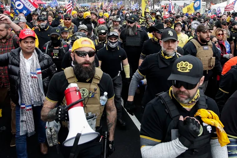 Far-right Proud Boys member Jeremy Joseph Bertino, second from left, joins other supporters of President Donald Trump who are wearing attire associated with the Proud Boys as they attend a rally at Freedom Plaza, on Dec. 12, 2020, in Washington.