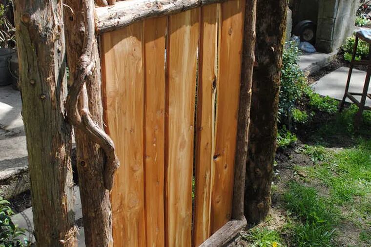 David Hughes created this 4-foot-tall garden gate using native Eastern red cedar and Moravian tiles.