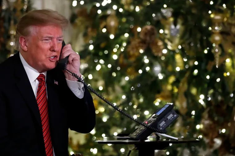 President Donald Trump speaks on the phone sharing updates to track Santa's movements from the North American Aerospace Defense Command (NORAD) Santa Tracker on Christmas Eve, Monday, Dec. 24, 2018.