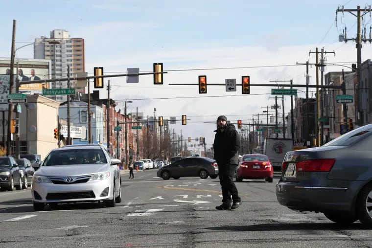 Gabriel Pechaceck, founder of the Washington Avenue Association of Businesses and Residents, looks west as he crosses Washington Avenue while walking on 8th Street on Friday, February 25, 2022.
