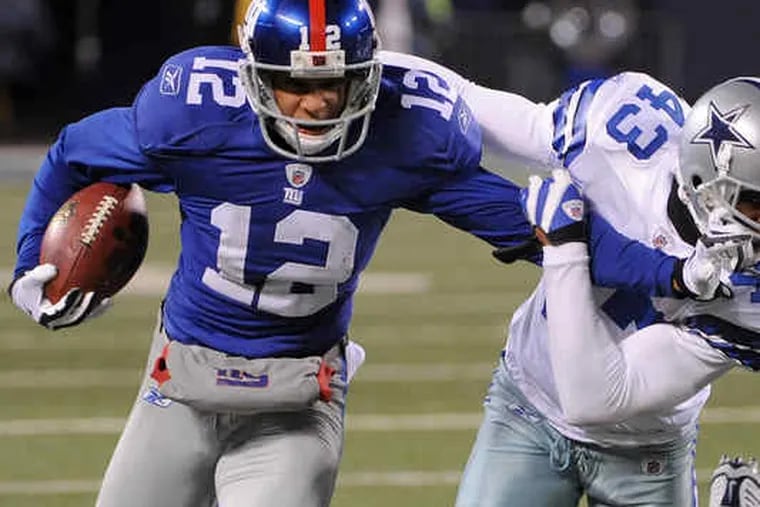 The Giants' Steve Smith, stiff-arming the Cowboys' Gerald Sensabaugh, will work against the nickel back.