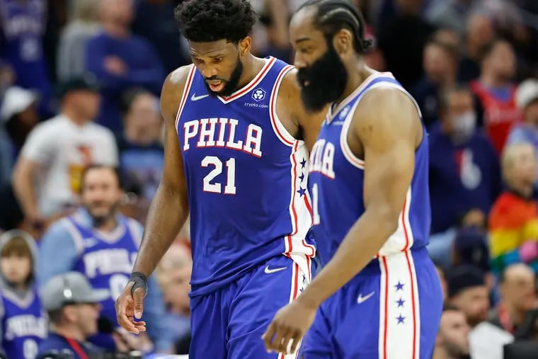 Sixers center Joel Embiid and guard James Harden walk off the court after a loss to the Miami Heat in Game 6 of the 2022 NBA playoffs.