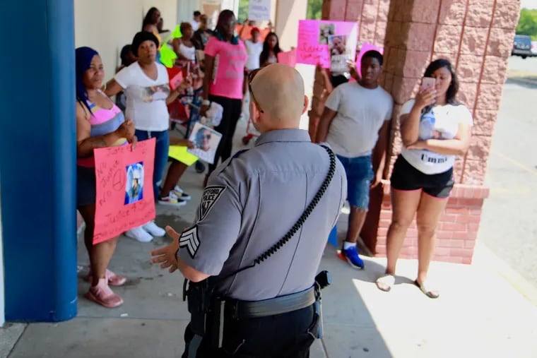 An unidentified Deptford police officer confronts family and supporters of LaShanda Anderson on July 01 outside the Marshalls in Deptford where she was shot and killed by a Deptford Sergeant on June 09.