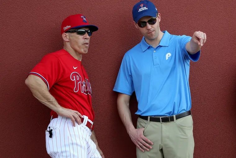 Phillies manager Joe Girardi, left, talks with general manager Matt Klentak during the Phillies' original spring training in Clearwater, Fla.