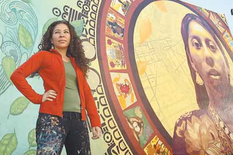 Artist Michelle Ortiz in front of a mural she created at 1515 S. Sixth St. that focuses on Hispanic heritage and immigration. "I always knew that I needed to stand up if someone was unjust and speak out and not be afraid." (David Maialetti / Staff Photographer)