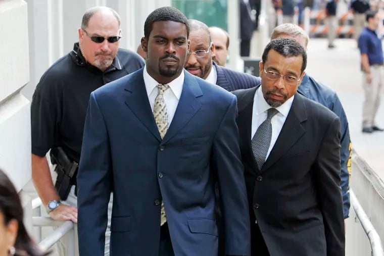 Then-Atlanta Falcons football player Michael Vick arrives with his attorney Billy Martin (right) at federal court in Richmond, Va., for his guilty plea in 2007.