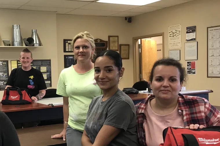 Women In Nontraditional Careers Trades Readiness pre-apprentices with their new tool bags: (from left) Christina McNeill, instructor Erin O'Brien-Hofmann, Michelle Burgos and Dalila Lahlou. It's the first all women's pre-apprenticeship program in Philadelphia since the 1980s.