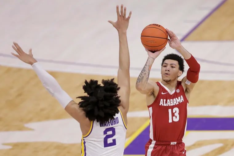 Alabama guard Jahvon Quinerly (13) shoots a 3-pointer in front of LSU forward Trendon Watford (2) in the first half of Tuesday's game.