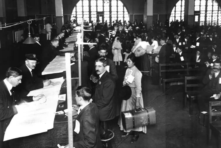 Immigrants arrive for  inspection at Ellis Island in the early 1900s