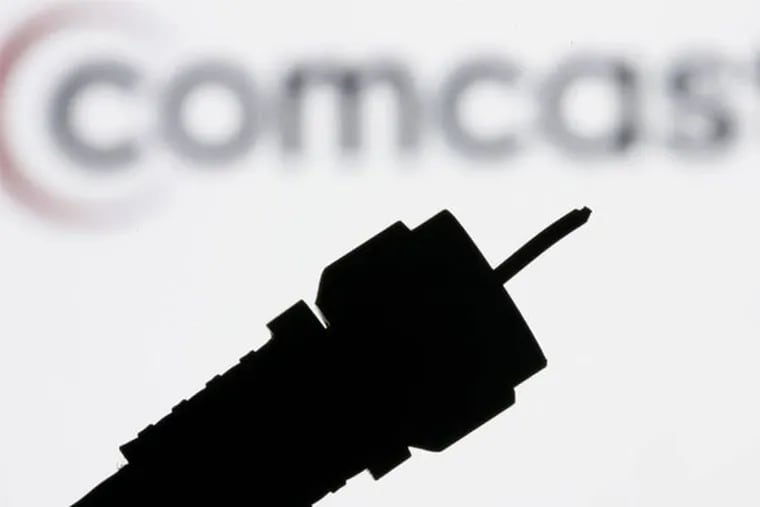 FILE - In this July 30, 2008 file photo illustration, a silhouetted coaxial cable is photographed with the Comcast Corp. logo in the background in Philadelphia.Comcast Corp. announced Thursday that it is buying Time Warner Cable Inc. for $45.2 billion in stock. The deal combines two of the nation's top pay TV and Internet service companies and makes Comcast, which also owns NBCUniversal, a dominant force in both creating and delivering entertainment to U.S. homes. (AP Photo/Matt Rourke, file)