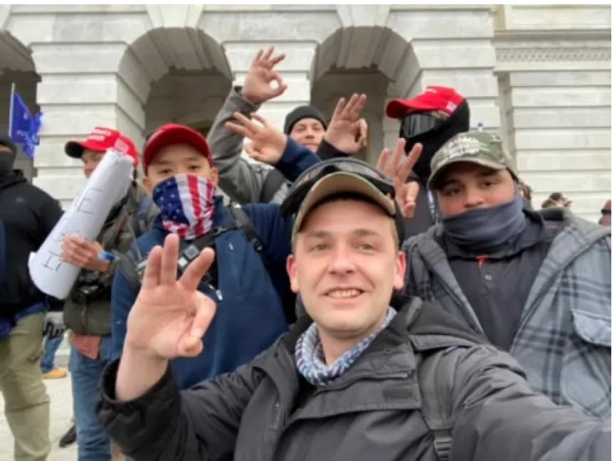 Zach Rehl (front), snaps a selfie with Freedom Vy (left), Isaiah Giddings (right), and Brian Healion (back right), according to investigators.
