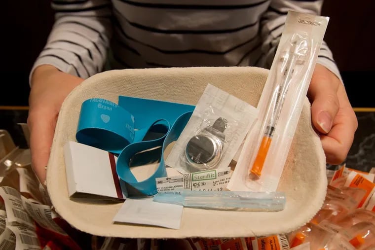Registered nurse Sammy Mullally holds a tray of supplies to be used by a drug addict at the Insite safe injection clinic in Vancouver, B.C., North America’s first and only legal injection site.