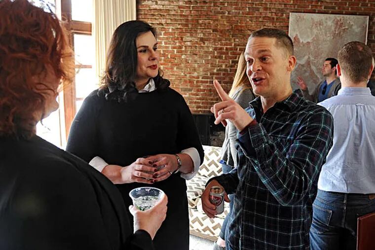 Kim Otto (left) and Jay Lassiter co-host a brunch at Lassiter's house in Cherry Hill. 'We're trying to figure out how to leverage this historic visit,' Jay Lassiter said.