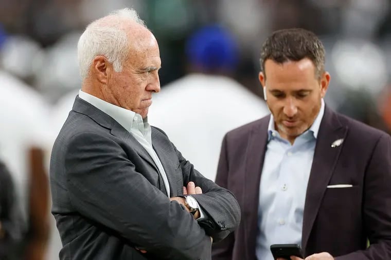 Eagles Chairman and Chief Executive Officer Jeffrey Lurie with team Executive Vice President/General Manager Howie Roseman looking down at his mobile phone before the Eagles played Las Vegas Raiders on Sunday, October 24, 2021 in Las Vegas.