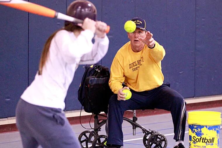 Coach Heydet played fast-pitch softball for 30 years. (Charles Fox/Staff Photographer)