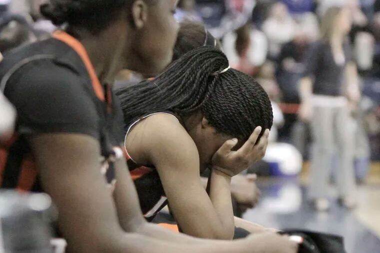 With the outcome certain , Woodrow Wilson's Lyayshia Stevens holds her head in her hands after coming out of the game in the fourth quarter. ELIZABETH ROBERTSON / Staff Photographer