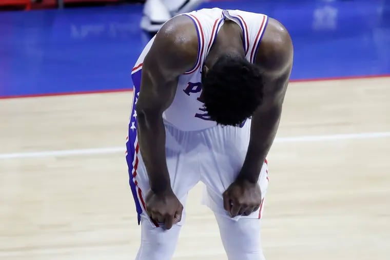 Sixers center Joel Embiid looks down waiting for the clock to end Game 7 against the Atlanta Hawks of the NBA Eastern Conference playoff semifinals on Sunday.  The Sixers lost to the Hawks 103-96.