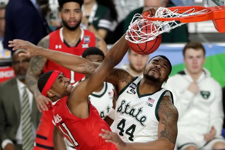 Tariq Owens (left) dunks over Michigan State's Nick Ward during the Red Raiders' win in the semifinals on Saturday in Minneapolis. Owens played at Tennessee and St. John's before transferring to Texas Tech as a grad student.