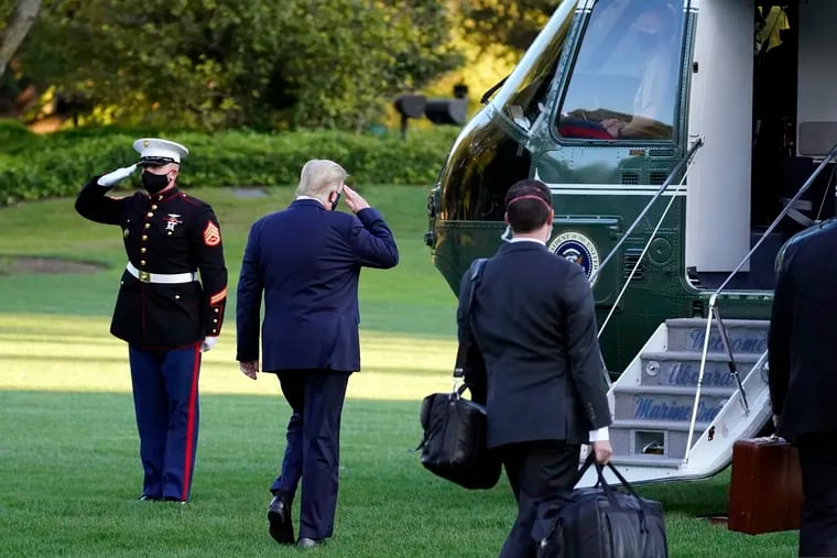 President Donald Trump salutes as he boards Marine One as he leaves the White House to go to Walter Reed National Military Medical Center after he tested positive for COVID-19, Friday, Oct. 2, 2020, in Washington.