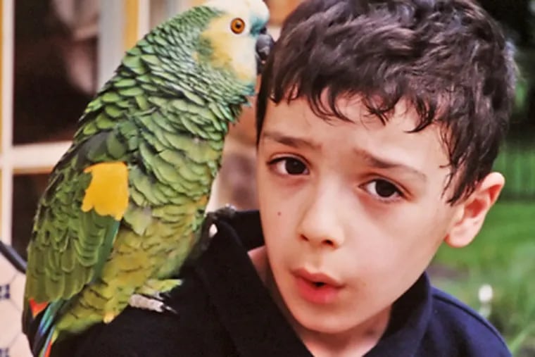Jake Miller and the family parrot, Tex, are shown in a family photo.