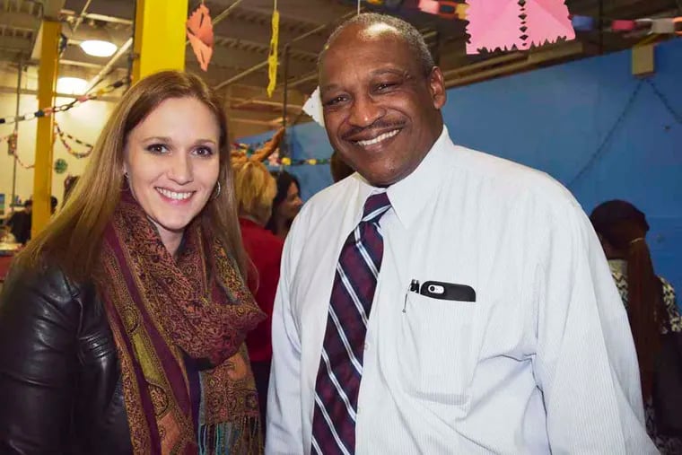 Amy Westphal of Snider Foundation (left) and Bryan Carter,  president and CEO of the Gesu School at the C.B.Community School Holiday Party. For the Inquirer/Maggie Henry Corcoran