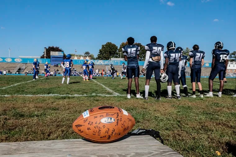 Washington High's JV team presented a signed ball to Roxborough High's junior varsity football team in the team's first return to the field following the September shooting that killed teammate Nicolas Elizalde.