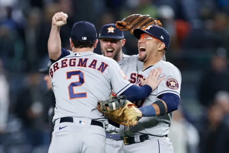 Houston Astros teammates Alex Bregman (left), Ryan Pressly (center) and Yuli Gurriel (right) celebrate after defeating the New York Yankees in Game 4 of the American League Championship Series on Sunday. Houston enters the World Series has a sizable favorite to beat the Philadelphia Phillies. (Photo by Sarah Stier/Getty Images)