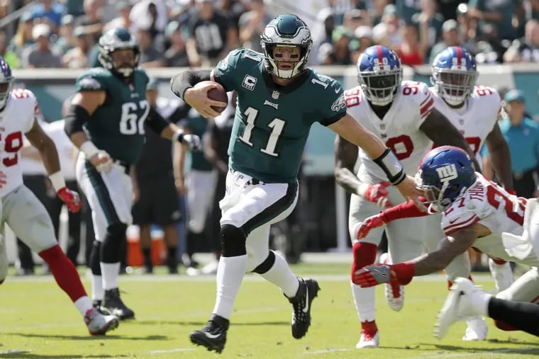 Eagles’ Carson Wentz scrambles for a 1st down against the Giants in the 2nd quarter. Philadelphia Eagles play the New York Giants in Philadelphia, PA on September 24, 2017.  DAVID MAIALETTI / Staff Photographer