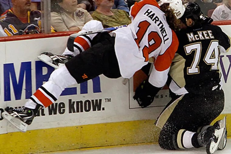 Scott Hartnell flies into the boards alongside Penguins' Jay McKee, during the third period. (AP Photo/Keith Srakocic)
