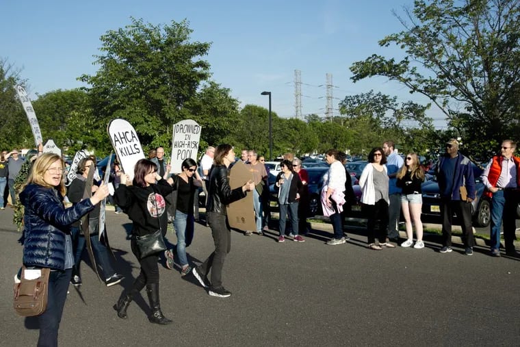 Protesters marched along a line of people waiting outside as U.S. Rep. Tom MacArthur held a town meeting in Willingboro last year.
