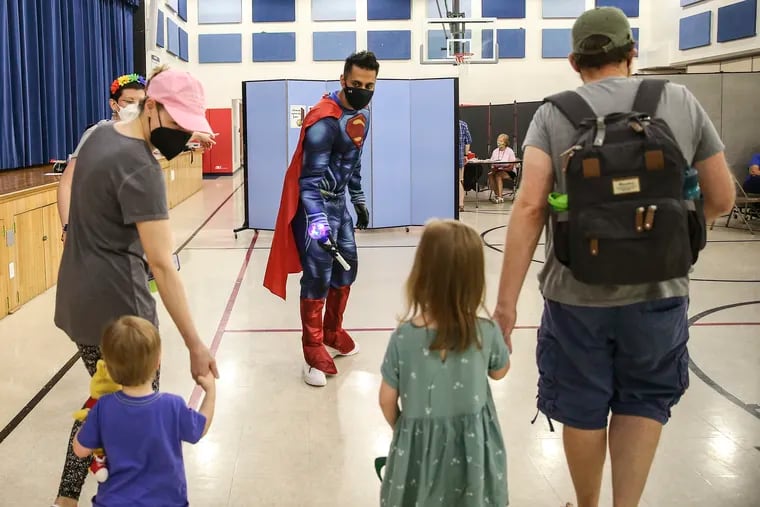Skippack pharmacist Dr. Mayank Amin leads a family in a day clinic at the Hatfield Elementary School for covid vaccines for children under 5 in Hatfield on Thursday, June 30.