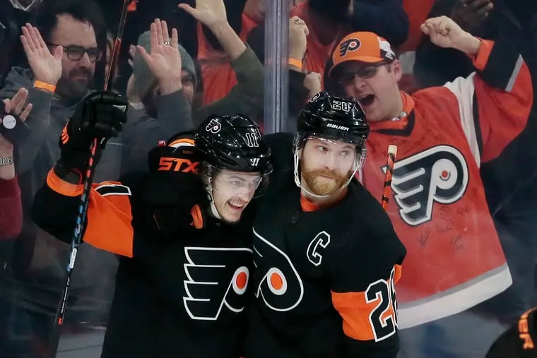 Flyers right winger Travis Konecny (left) and center Claude Giroux celebrating Konecny's goal against the Los Angeles Kings on Jan. 18.