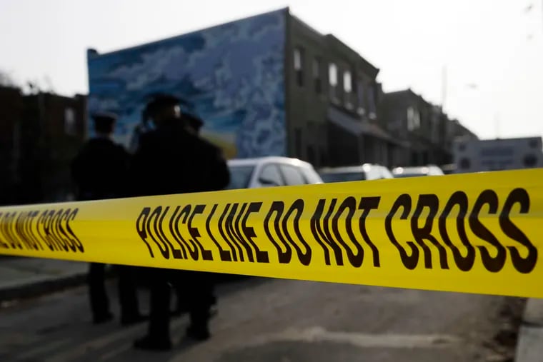 In this Nov. 19, 2018, file photo, police gather at the scene of a quadruple fatal shooting in Philadelphia. Philadelphia's homicide rate is the highest in over a decade, as a particularly violent summer morphed into a deadly fall and the mayor declared gun violence a public health emergency.