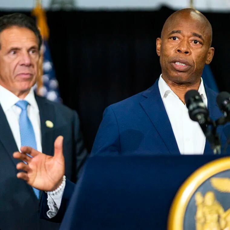 New York City Mayor Eric Adams speaks to the media accompanied by ex-Gov. Andrew Cuomo during his 2021 campaign. Both men were hit with lawsuits accusing them of sexual assaults before a state window for legal action closed on Thanksgiving.
