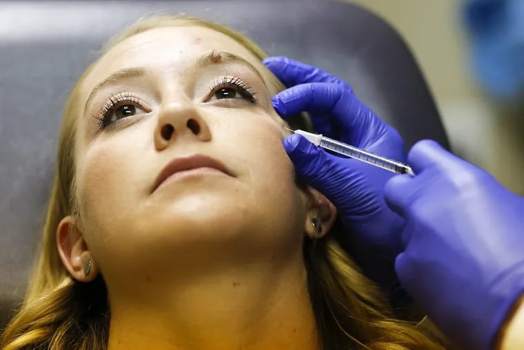 Katy Young, 28 of New Jersey, receives a Botox injection from a plastic surgeon in Cherry Hill, New Jersey on Thursday, July 13, 2017.